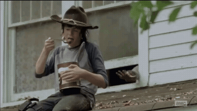 Young Boy In Cowboy Hat Eating On Roof GIF