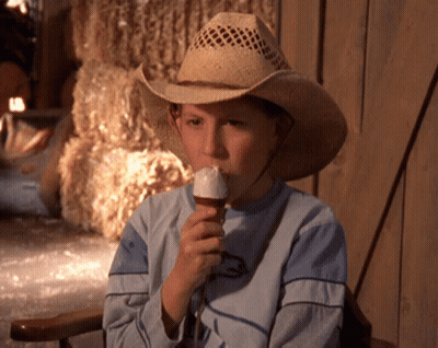 Young Boy In Cowboy Hat Eating Vanilla Ice Cream GIF