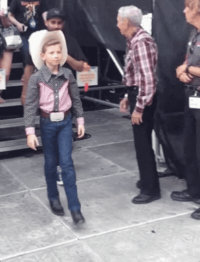 Young Boy In Cowboy Outfit Walking GIF