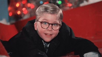 Young Boy In Glasses And Suit Laying On Ground GIF