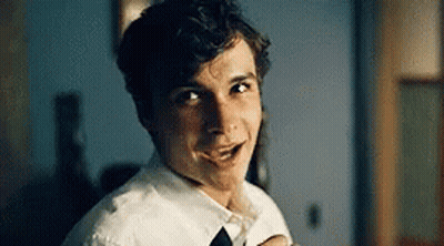 Young Boy In Glasses And Tie Looking At Camera GIF
