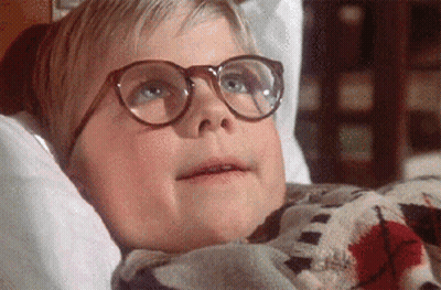 Young Boy In Glasses Laying On Bed GIF