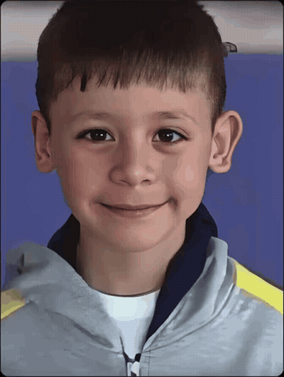 Young Boy In Grey Jacket With M GIF