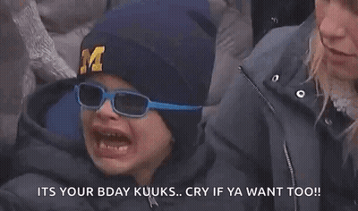 Young Boy In Hat With Letter M Crying While Woman Looks On GIF