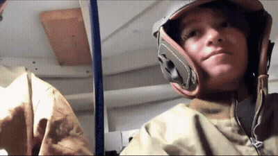 Young Boy In Helmet And Jacket Looking At Camera GIF