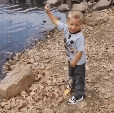 Young Boy In Mickey Mouse Shirt On Shore GIF