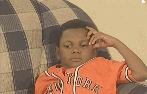 Young Boy In New York Jersey Sitting On Couch GIF