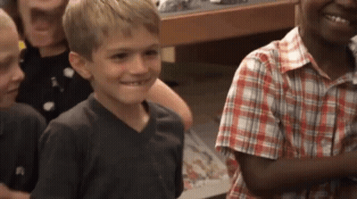 Young Boy In Plaid Shirt Smiling GIF