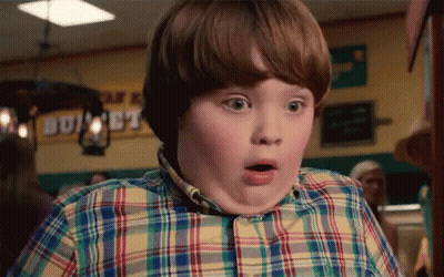 Young Boy in Plaid Shirt Surprised by Buffet Sign