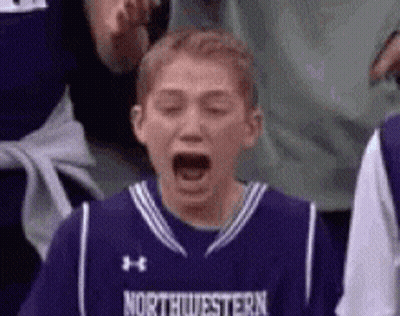 Young Boy In Purple Northwestern Jersey Yawning GIF