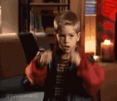 Young Boy In Red Jacket Sitting With Laptop And Candle GIF