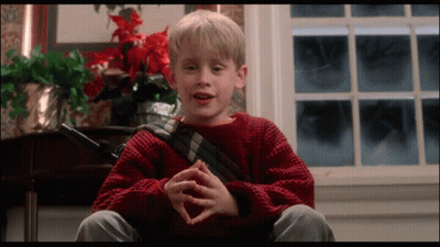 Young Boy In Red Sweater Sitting At Window GIF