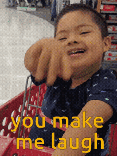Young Boy In Shopping Cart Saying You Make Me Laugh GIF