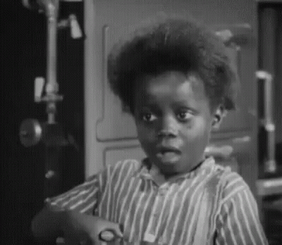 Young Boy In Striped Shirt Holding Scissors GIF