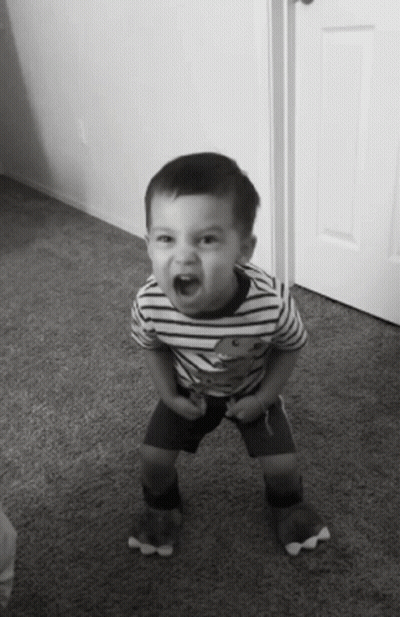 Young Boy In Striped Shirt With Teddy Bear Raising Fist GIF