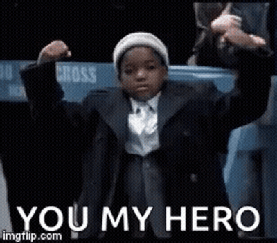Young Boy In Suit And Tie With Hands In Air GIF