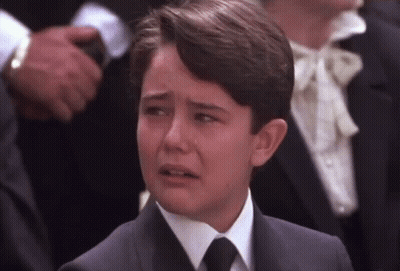 Young Boy In Suit Crying In Crowd GIF