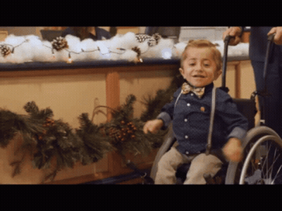 Young Boy In Wheelchair With Bow Tie GIF