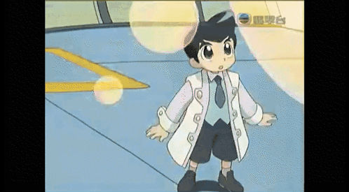Young Boy In White Coat And Tie Standing In Room GIF