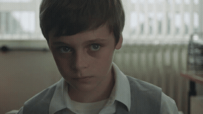 Niño con camisa blanca y chaleco gris GIF