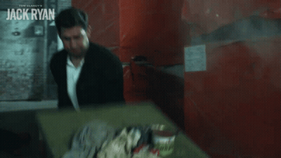 Young Boy In White Sweater Crawling Under Red Curtain GIF