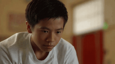 Young Boy In White T-Shirt Looking Down GIF