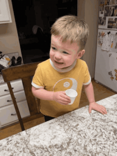 Young Boy In Yellow Shirt Holding Cup GIF