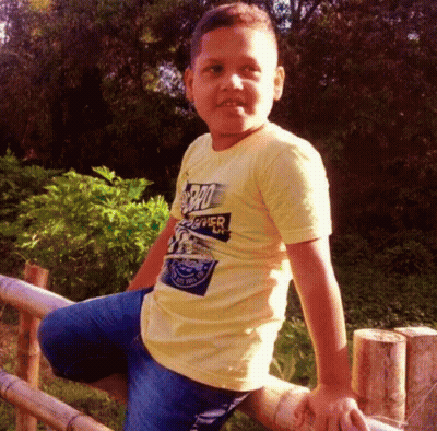 Young Boy In Yellow Superhero Shirt GIF