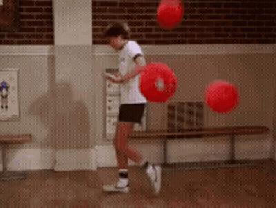 Young Boy Jumping With Red Balls GIF