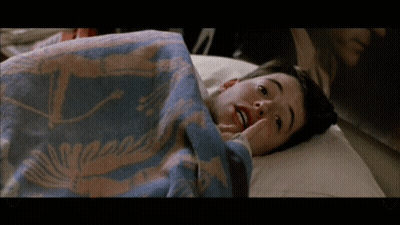 Young Boy Laying In Bed With Whale Blanket GIF