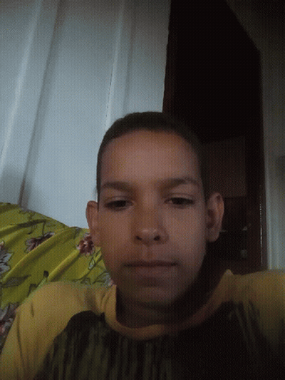 Young Boy Laying On Bed With Yellow Blanket GIF