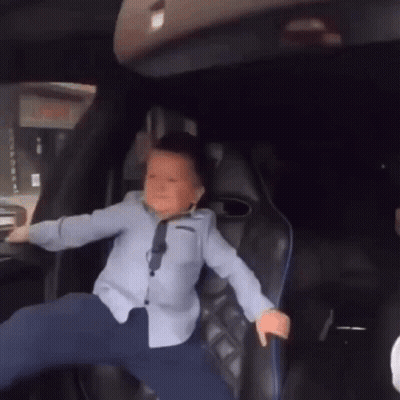 Young Boy Legs Crossed In Back Seat GIF