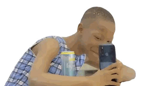 Young Boy Looking At Cell Phone Next To Fayum Soda Sticker