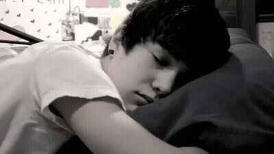 Young Boy Lying In Bed Eyes Closed GIF