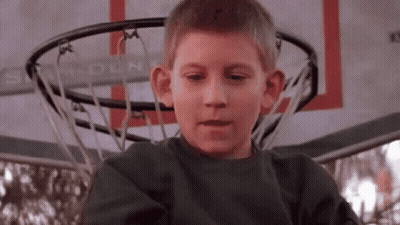 Young Boy Making Funny Face At Basketball Hoop GIF