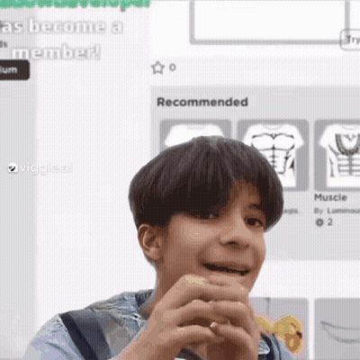 Young Boy Making Funny Face Holding Hands In Front Of Computer Screen GIF