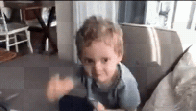 Young Boy Making Funny Face On Couch GIF