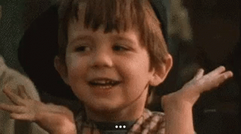 Young Boy Making Funny Face With Hands Outstretched GIF