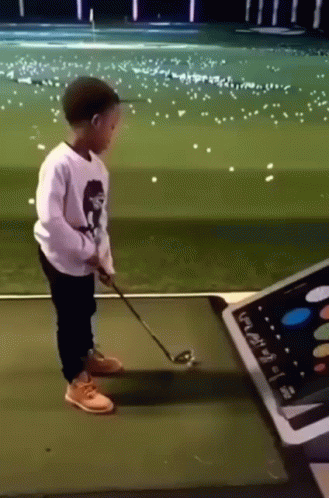Young Boy Playing Golf GIF