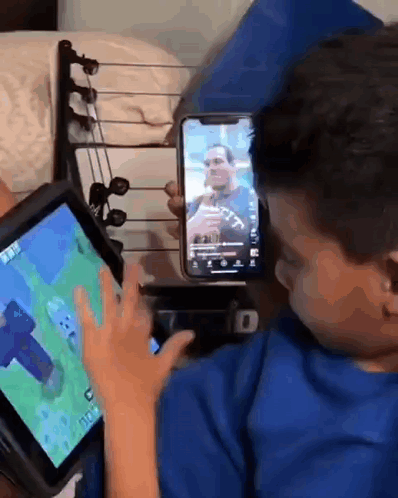 Young Boy Playing Video Game On Tablet And Cell Phone GIF