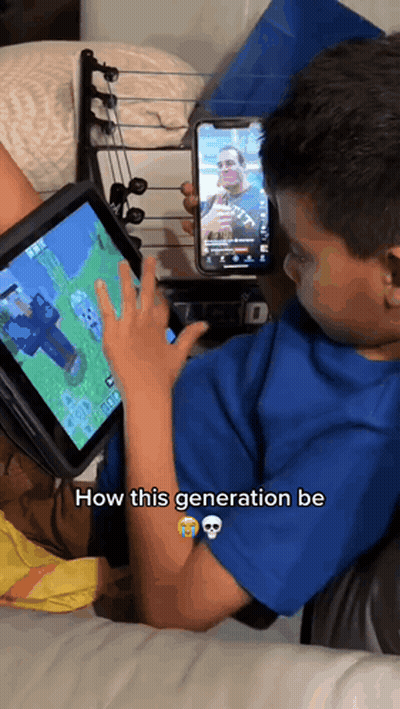 Young Boy Playing Video Game On Tablet Holding Phone GIF