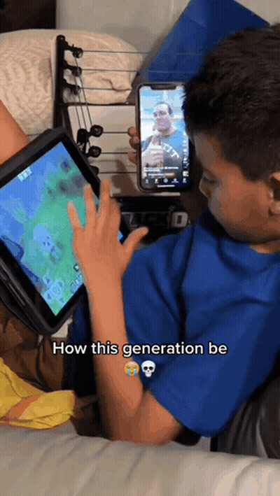 Young Boy Playing Video Game On Tablet While Holding Cell Phone How This Generation Be GIF