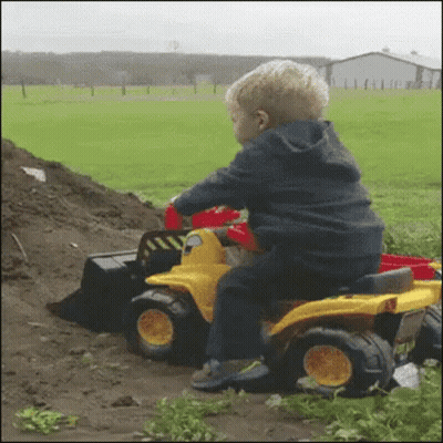 Young Boy Playing With Toy Bulldozer GIF