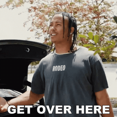 Young Boy Running On Football Field With Players GIF