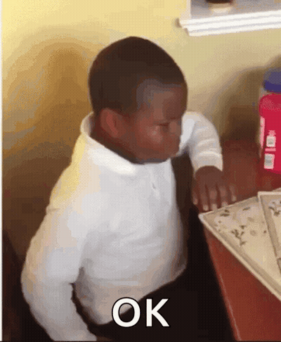 Young Boy Sitting At Desk Eyes Closed Saying Ok GIF