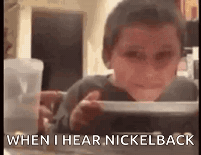 Young Boy Sitting At Table Saying When I Hear Nickelback GIF