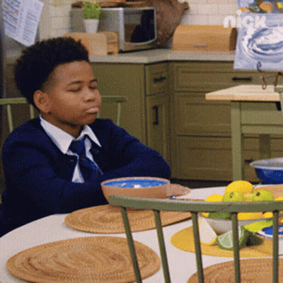 Young Boy Sitting At Table With Bowl Of Food And Nickelodeon Logo GIF
