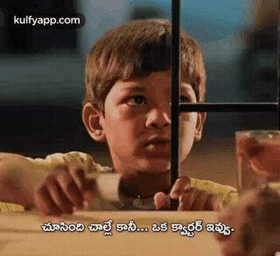 Young Boy Sitting Behind Fence GIF