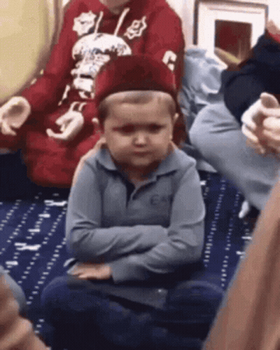 Young Boy Sitting Crossed Arms Wearing Hat GIF