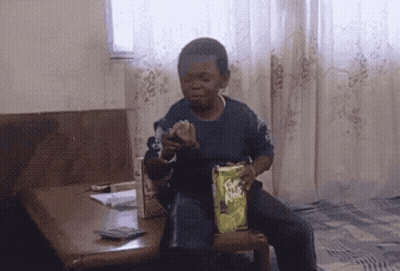 Young Boy Sitting In Chair Holding Fritos GIF